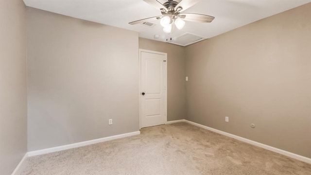 empty room with light colored carpet, visible vents, baseboards, and a ceiling fan