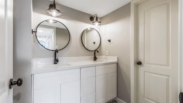 full bath featuring double vanity, a sink, and visible vents