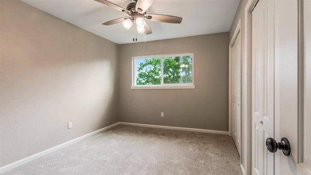 unfurnished bedroom with carpet flooring, a ceiling fan, baseboards, and a closet
