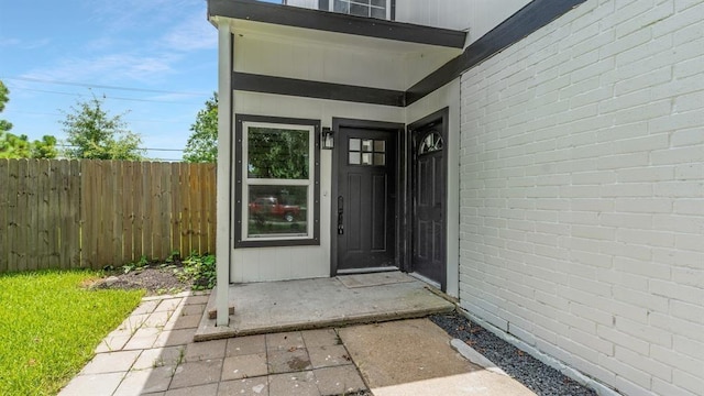 view of exterior entry with fence