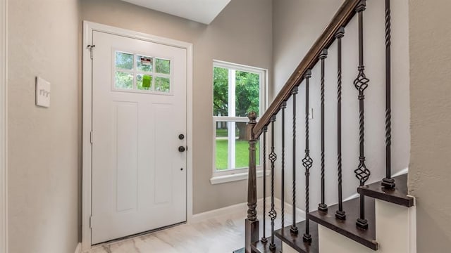 entrance foyer with baseboards, a wealth of natural light, and stairway