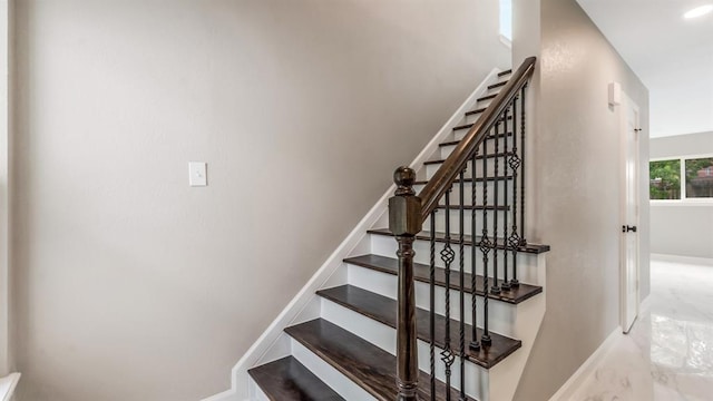 stairs with baseboards and marble finish floor
