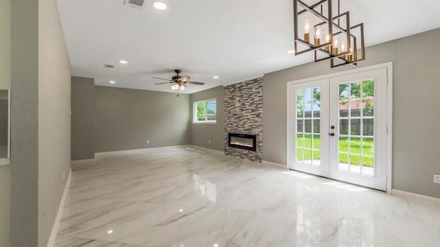 unfurnished living room with french doors, marble finish floor, a stone fireplace, and baseboards