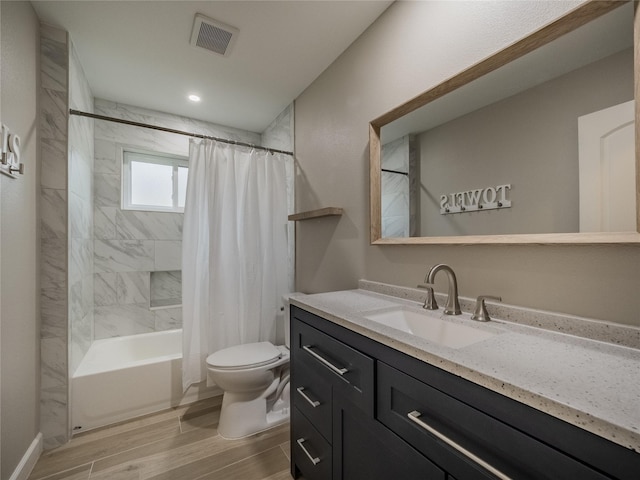 1701 N Park Way Dr, Deer Park, TX 77536 - bathroom featuring toilet, wood finished floors, vanity, and shower / tub combo