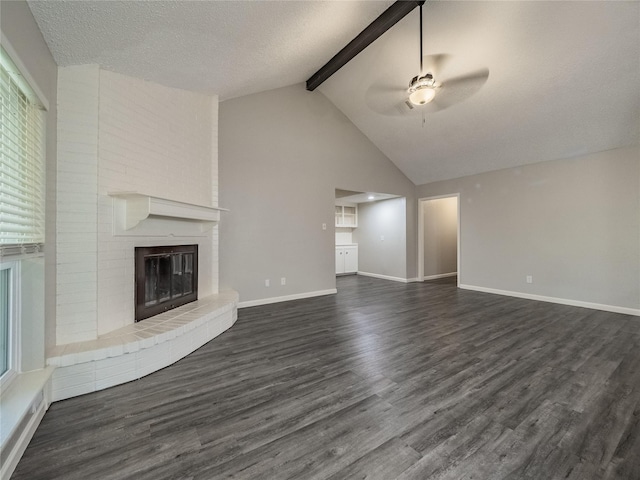 1701 N Park Way Dr, Deer Park, TX 77536 - unfurnished living room featuring beam ceiling, a ceiling fan, a brick fireplace, dark wood finished floors, and baseboards