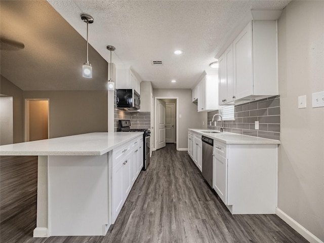 1701 N Park Way Dr, Deer Park, TX 77536 - kitchen featuring stainless steel appliances, baseboards, dark wood-type flooring, tasteful backsplash, and light countertops