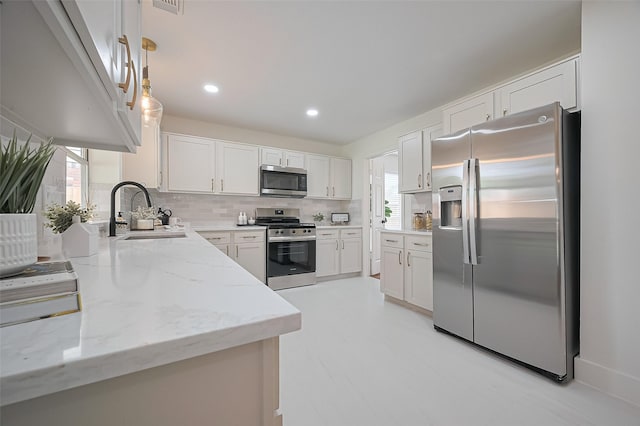 5615 Haven Point Dr, Houston, TX 77084 - kitchen with appliances with stainless steel finishes, plenty of natural light, light stone counters, and a sink