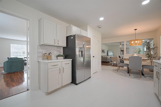 5615 Haven Point Dr, Houston, TX 77084 - kitchen with recessed lighting, decorative light fixtures, visible vents, stainless steel fridge with ice dispenser, and light countertops