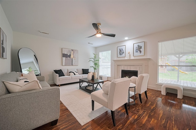 5615 Haven Point Dr, Houston, TX 77084 - living area featuring dark wood-type flooring, visible vents, a fireplace, ceiling fan, and baseboards