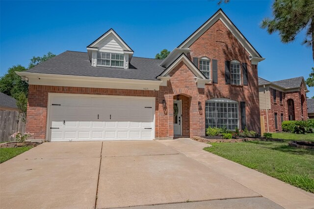 5615 Haven Point Dr, Houston, TX 77084 - traditional home featuring concrete driveway, an attached garage, a front lawn, and brick siding