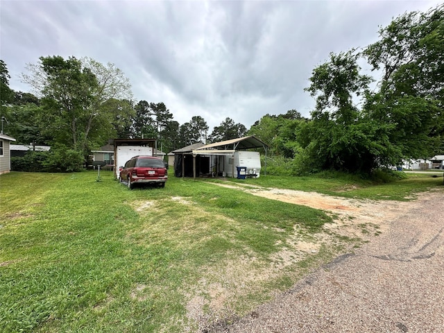 11480 Persimmon St, Willis, TX 77318 - view of green lawn featuring a carport and driveway