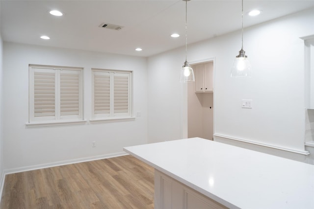 18007 Ravenfield Dr, Houston, TX 77084 - kitchen with light countertops, light wood finished floors, visible vents, decorative light fixtures, and recessed lighting