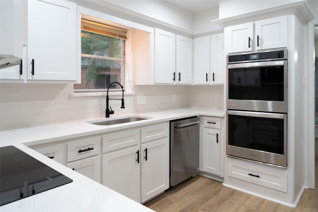 18007 Ravenfield Dr, Houston, TX 77084 - kitchen with light wood finished floors, tasteful backsplash, a sink, and stainless steel appliances