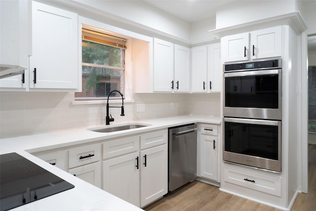18007 Ravenfield Dr, Houston, TX 77084 - kitchen with tasteful backsplash, light wood-style flooring, a sink, and stainless steel appliances