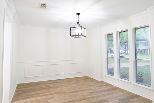 18007 Ravenfield Dr, Houston, TX 77084 - unfurnished dining area featuring ornamental molding, baseboards, a chandelier, light wood-style floors, and visible vents