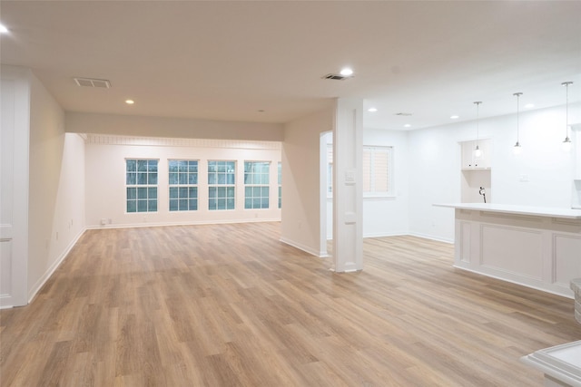 18007 Ravenfield Dr, Houston, TX 77084 - unfurnished living room featuring baseboards, recessed lighting, and light wood-style floors