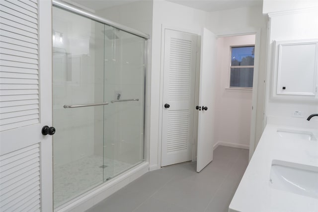 18007 Ravenfield Dr, Houston, TX 77084 - bathroom with tile patterned flooring, a sink, double vanity, and a shower stall