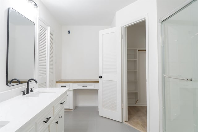 18007 Ravenfield Dr, Houston, TX 77084 - full bathroom featuring tile patterned floors, a sink, a shower stall, a spacious closet, and double vanity