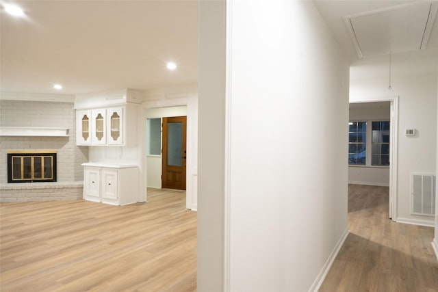 18007 Ravenfield Dr, Houston, TX 77084 - hall featuring light wood-type flooring, baseboards, visible vents, and attic access