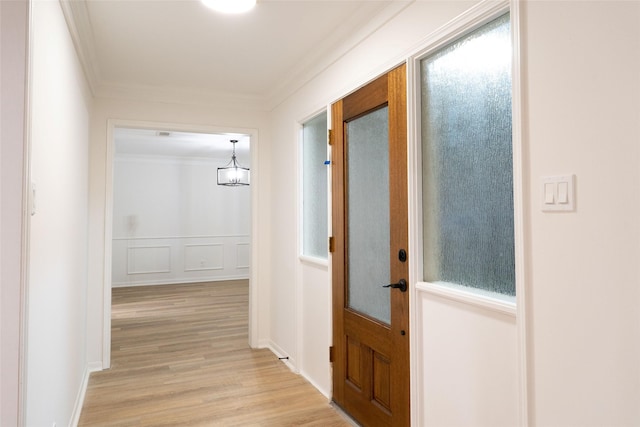 18007 Ravenfield Dr, Houston, TX 77084 - hall featuring light wood finished floors, a decorative wall, ornamental molding, and a wainscoted wall
