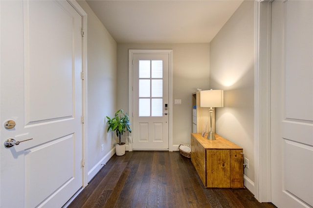 doorway featuring dark wood-style floors and baseboards