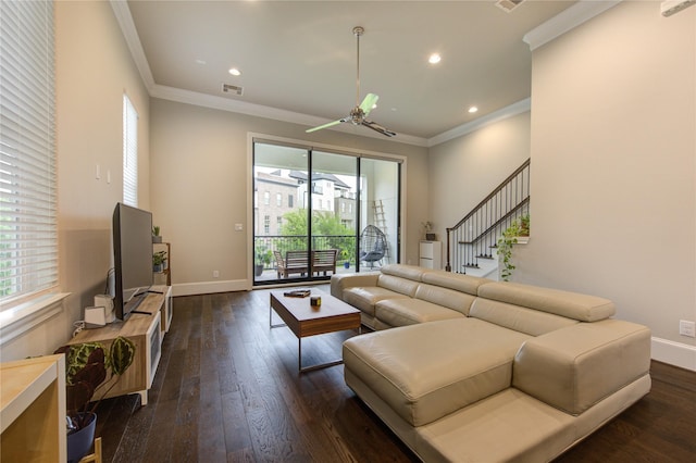 living area with crown molding, a ceiling fan, dark wood-style floors, baseboards, and visible vents