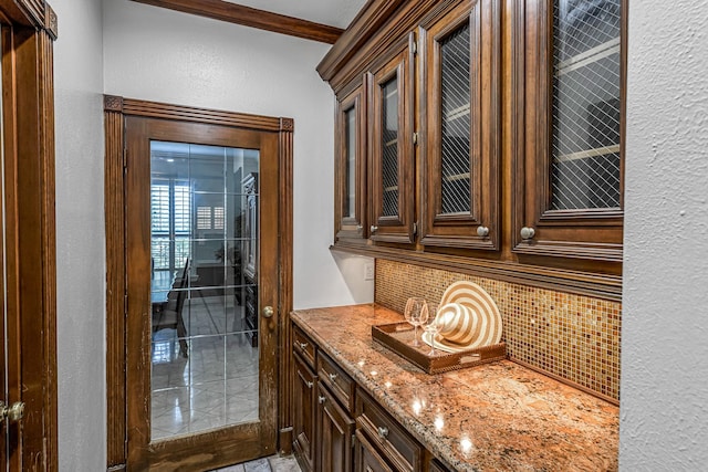 2926 Deer Creek Dr, Sugar Land, TX 77478 - bar with decorative backsplash, a textured wall, and ornamental molding