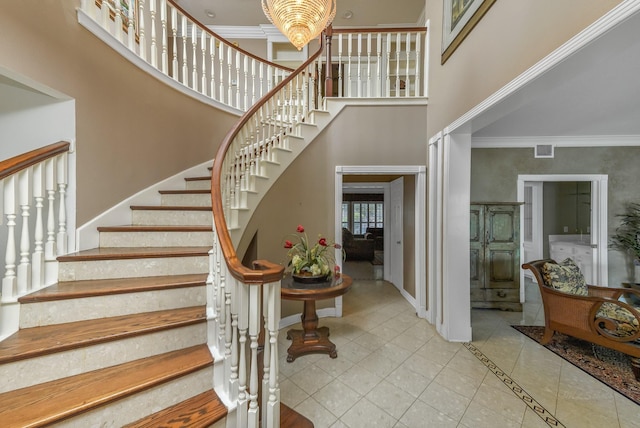 2926 Deer Creek Dr, Sugar Land, TX 77478 - stairs with a towering ceiling, ornamental molding, baseboards, tile patterned flooring, and a chandelier