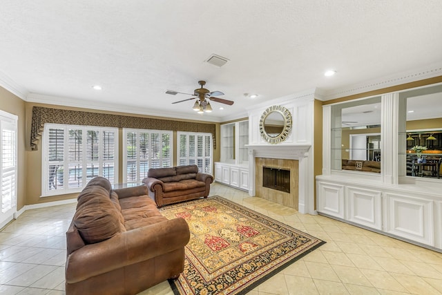 2926 Deer Creek Dr, Sugar Land, TX 77478 - living room featuring light tile patterned floors, ceiling fan, crown molding, a tiled fireplace, and recessed lighting