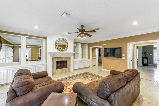 2926 Deer Creek Dr, Sugar Land, TX 77478 - living area with light tile patterned floors, ceiling fan, crown molding, a fireplace, and recessed lighting