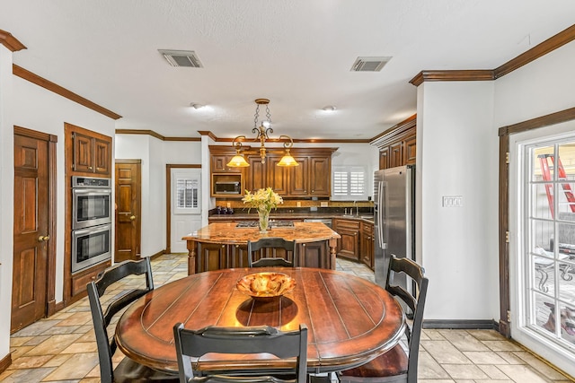 2926 Deer Creek Dr, Sugar Land, TX 77478 - dining space featuring plenty of natural light, ornamental molding, and baseboards