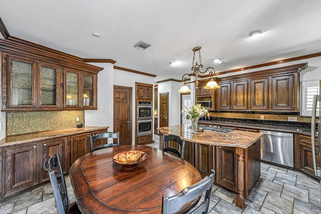 2926 Deer Creek Dr, Sugar Land, TX 77478 - kitchen with stainless steel appliances, stone tile floors, decorative backsplash, a kitchen island, and dark stone counters