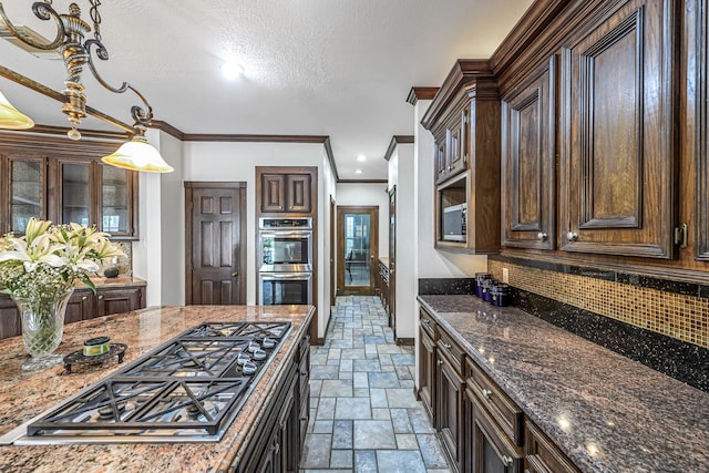 2926 Deer Creek Dr, Sugar Land, TX 77478 - kitchen with stone tile floors, stainless steel appliances, dark brown cabinetry, tasteful backsplash, and dark stone counters