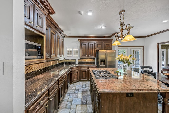 2926 Deer Creek Dr, Sugar Land, TX 77478 - kitchen with appliances with stainless steel finishes, tasteful backsplash, stone tile floors, dark brown cabinets, and dark stone counters
