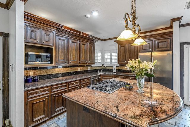 2926 Deer Creek Dr, Sugar Land, TX 77478 - kitchen with stainless steel appliances, stone tile flooring, a sink, crown molding, and backsplash