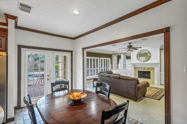 2926 Deer Creek Dr, Sugar Land, TX 77478 - dining area with ornamental molding, ceiling fan, french doors, and a premium fireplace