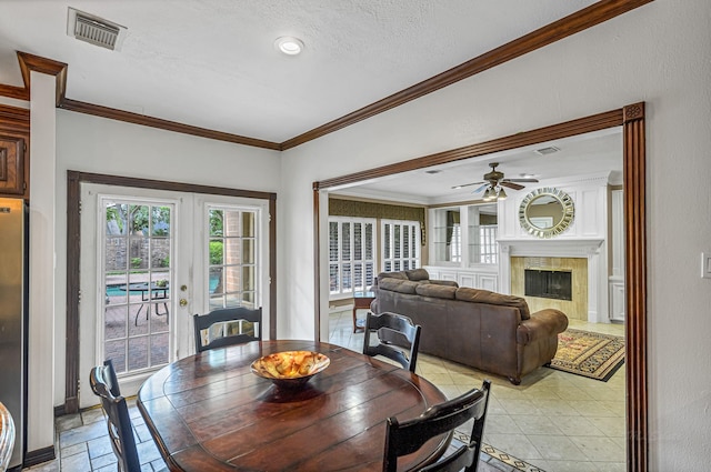 2926 Deer Creek Dr, Sugar Land, TX 77478 - dining room with ornamental molding, french doors, ceiling fan, and a high end fireplace