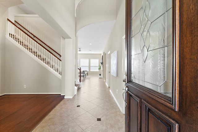 6123 Cameron Ct, League City, TX 77573 - foyer entrance featuring a high ceiling, light tile patterned flooring, baseboards, and stairs