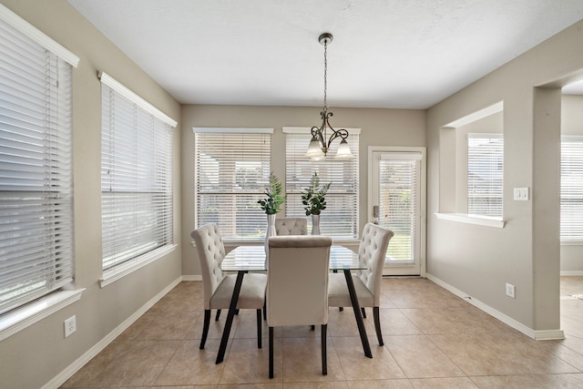 6123 Cameron Ct, League City, TX 77573 - dining space featuring baseboards, an inviting chandelier, and light tile patterned floors