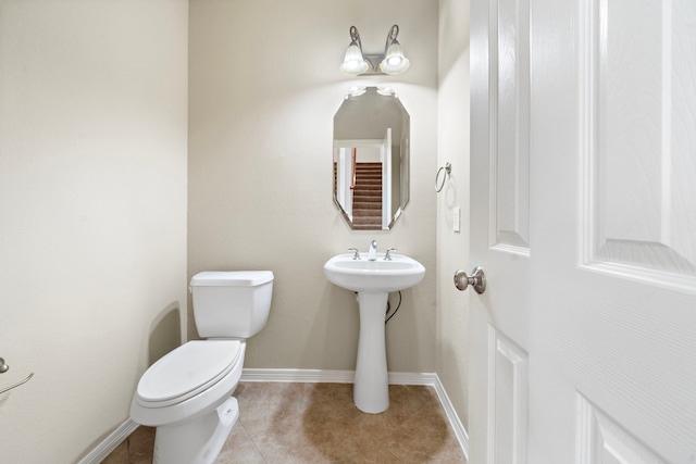 6123 Cameron Ct, League City, TX 77573 - half bathroom featuring baseboards, toilet, tile patterned floors, and a sink