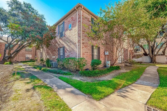 2255 Braeswood Park Dr Unit 294, Houston, TX 77030 - view of property exterior featuring brick siding and central AC
