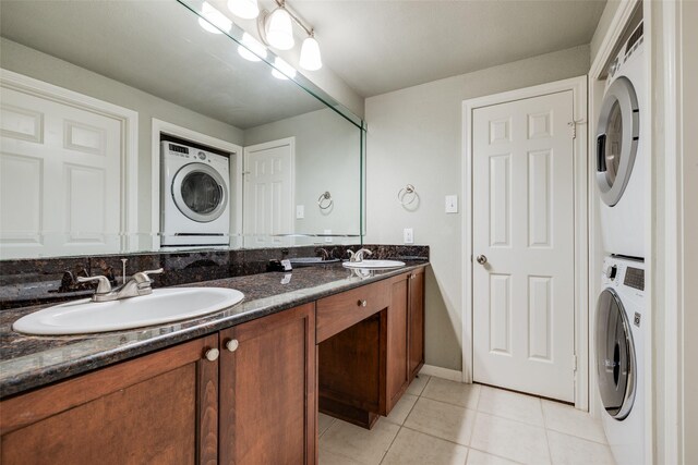 2255 Braeswood Park Dr Unit 294, Houston, TX 77030 - bathroom with estacked washer and dryer, tile patterned floors, and double vanity