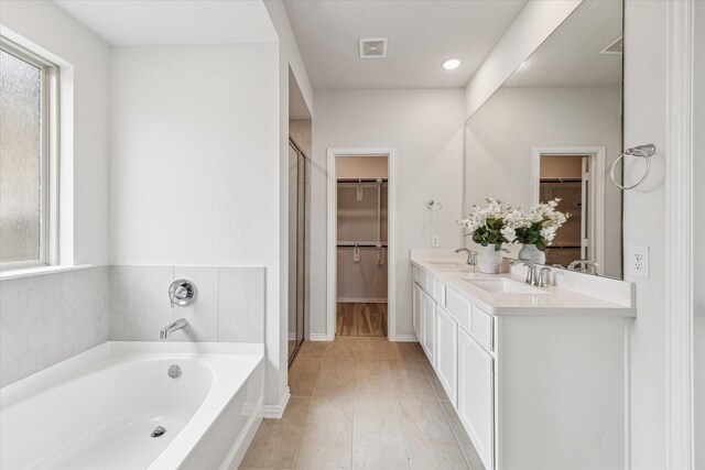 15039 Eves Necklace Ct, Cypress, TX 77433 - bathroom with a sink, a spacious closet, a garden tub, and visible vents