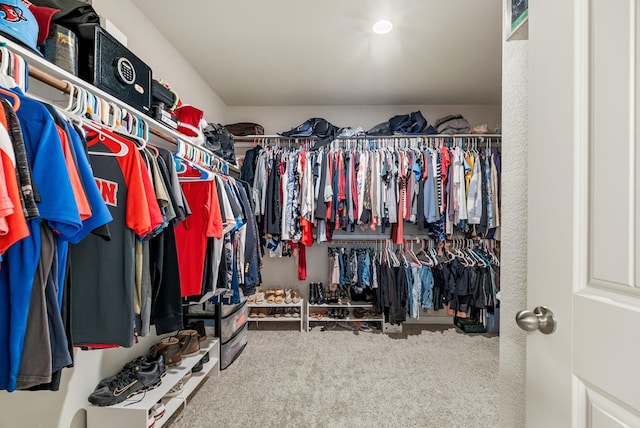 walk in closet featuring carpet flooring
