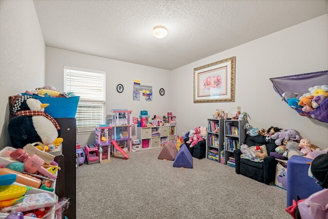 playroom featuring a textured ceiling and carpet