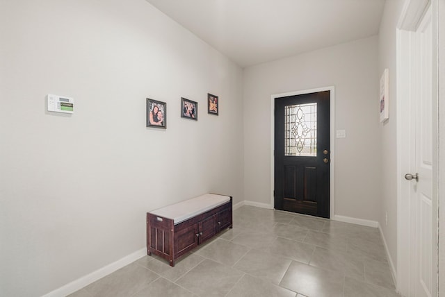 foyer with baseboards and light tile patterned floors