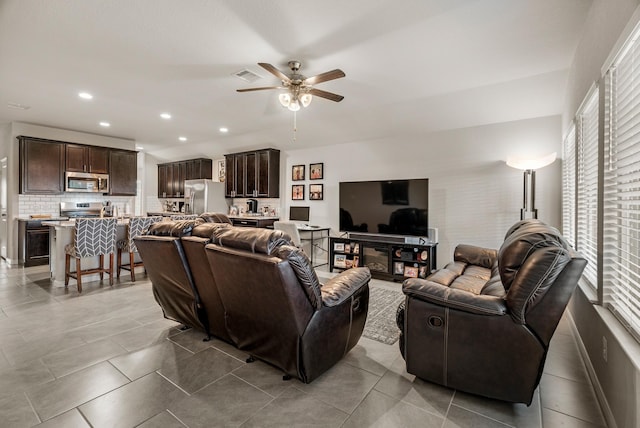 tiled living area with recessed lighting, visible vents, and a ceiling fan