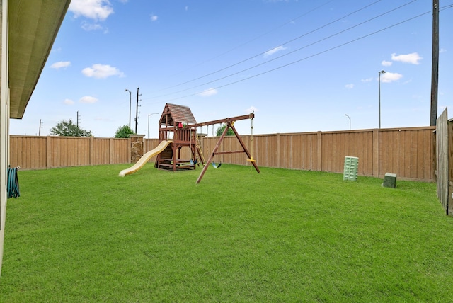 view of yard with a fenced backyard and a playground