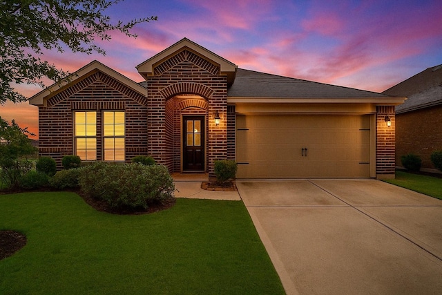 ranch-style house with brick siding, driveway, a front yard, and a garage