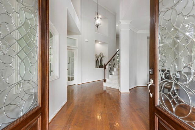 4911 Ontonagon Way, Spring, TX 77386 - entryway featuring baseboards, dark wood finished floors, crown molding, stairs, and ornate columns